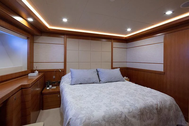 a room with a bed and a television aboard BEST OFF Yacht for Charter