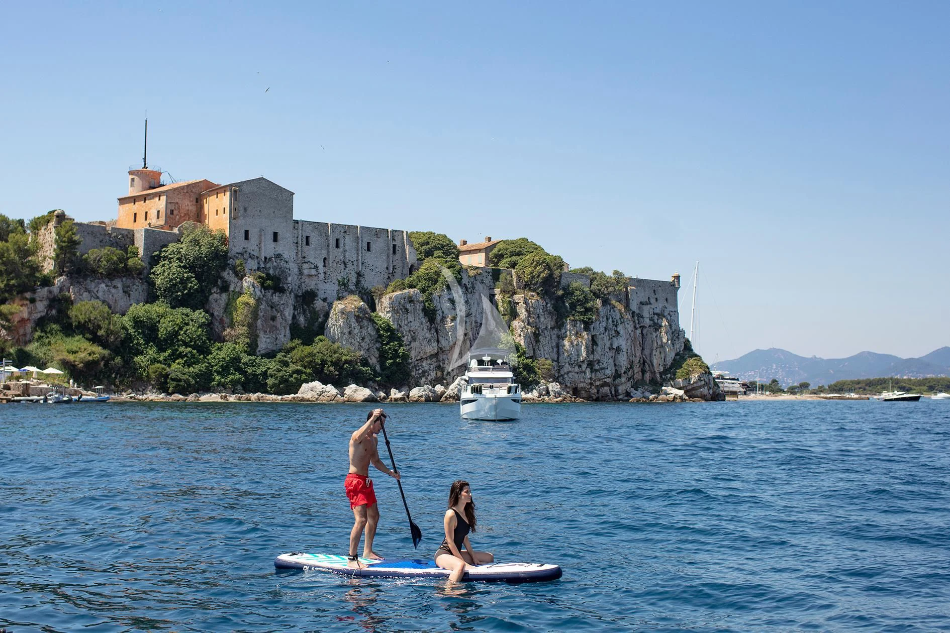 a couple of people paddle boarding aboard BEST OFF Yacht for Charter