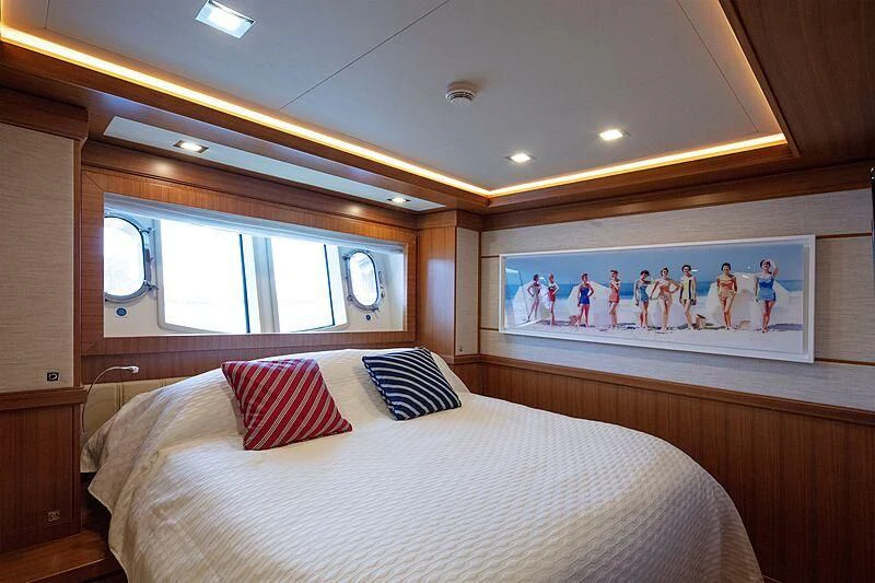 a bed with a painting on the wall aboard BEST OFF Yacht for Charter
