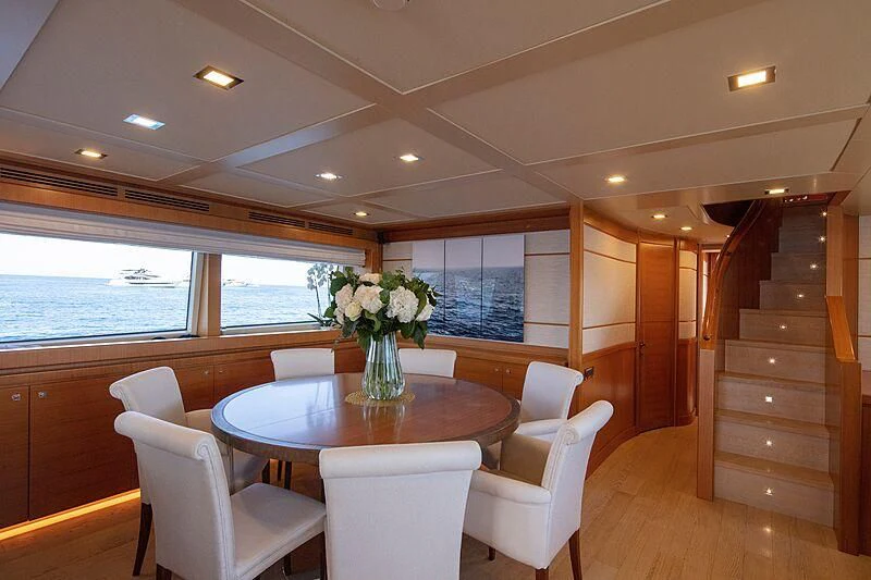 a dining room with a table and chairs aboard BEST OFF Yacht for Charter
