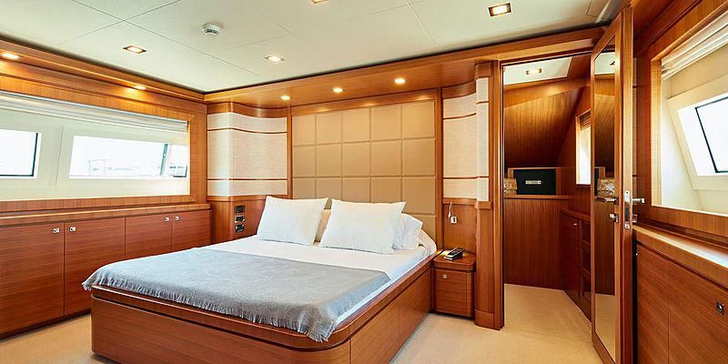 a room with a bed and a closet aboard BEST OFF Yacht for Charter
