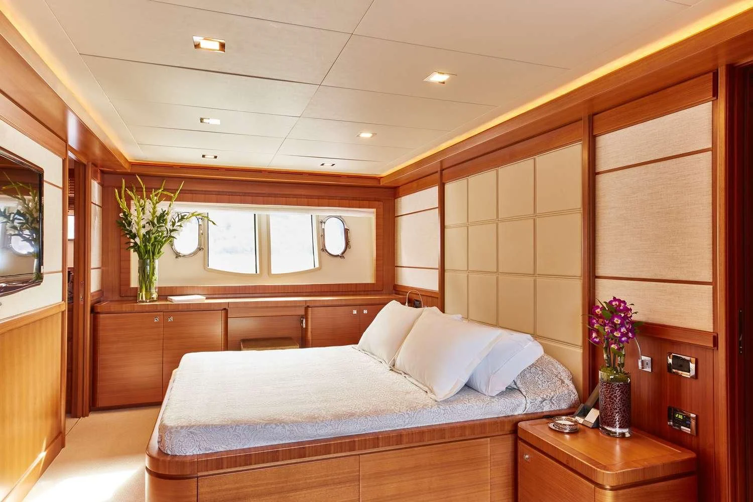 a bedroom with a bed and a plant in the corner aboard BEST OFF Yacht for Charter