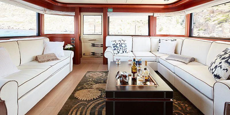 a room with a table and couch aboard BEST OFF Yacht for Charter