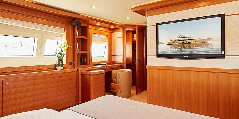 a room with a bed and a television aboard BEST OFF Yacht for Charter