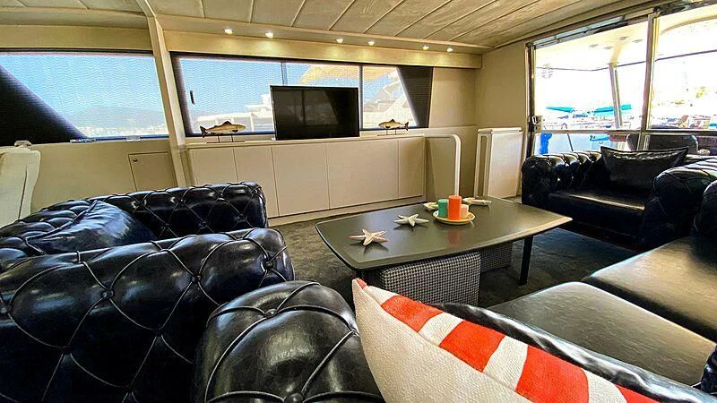 a room with couches and a television aboard BONA DEA Yacht for Sale