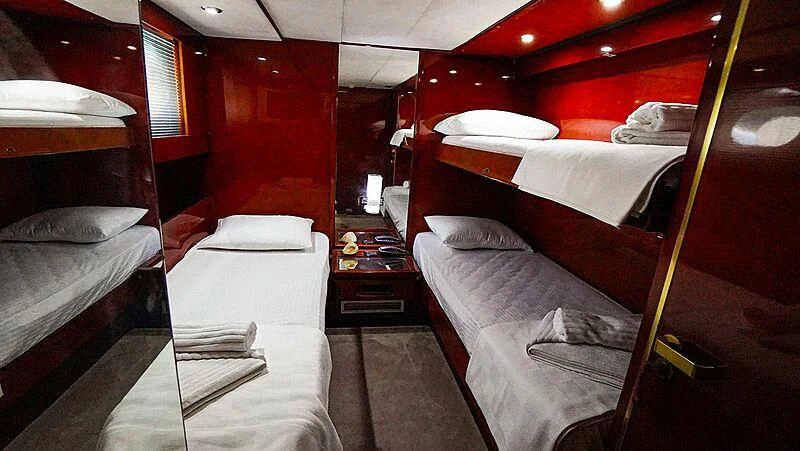 a room with red walls aboard BONA DEA Yacht for Sale