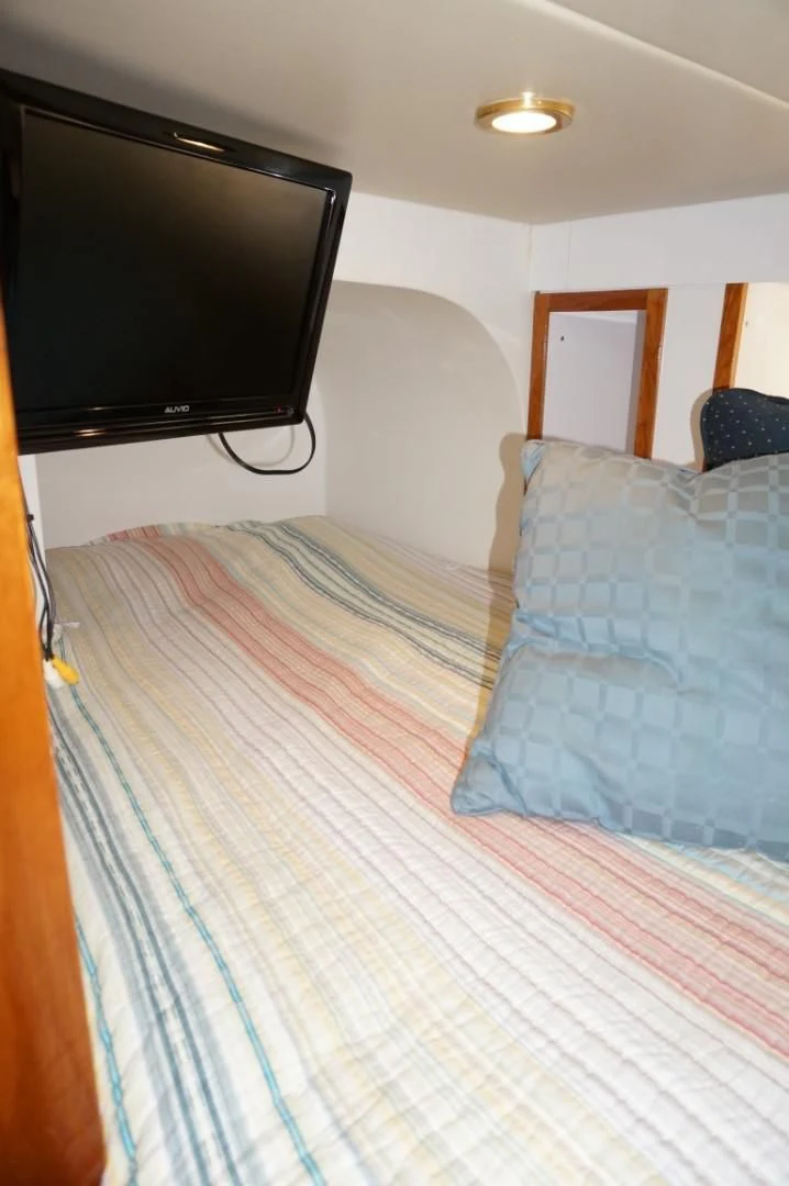 a tv on a bed aboard SWEET LADY Yacht for Sale