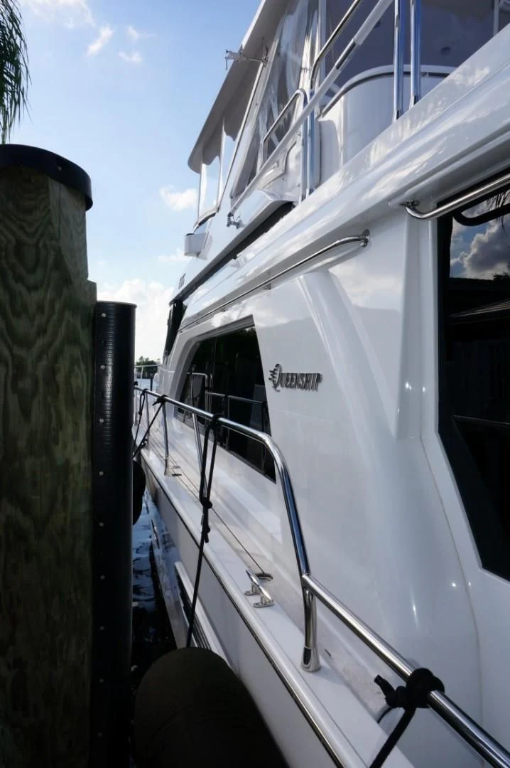 a white boat with a black railing aboard SWEET LADY Yacht for Sale