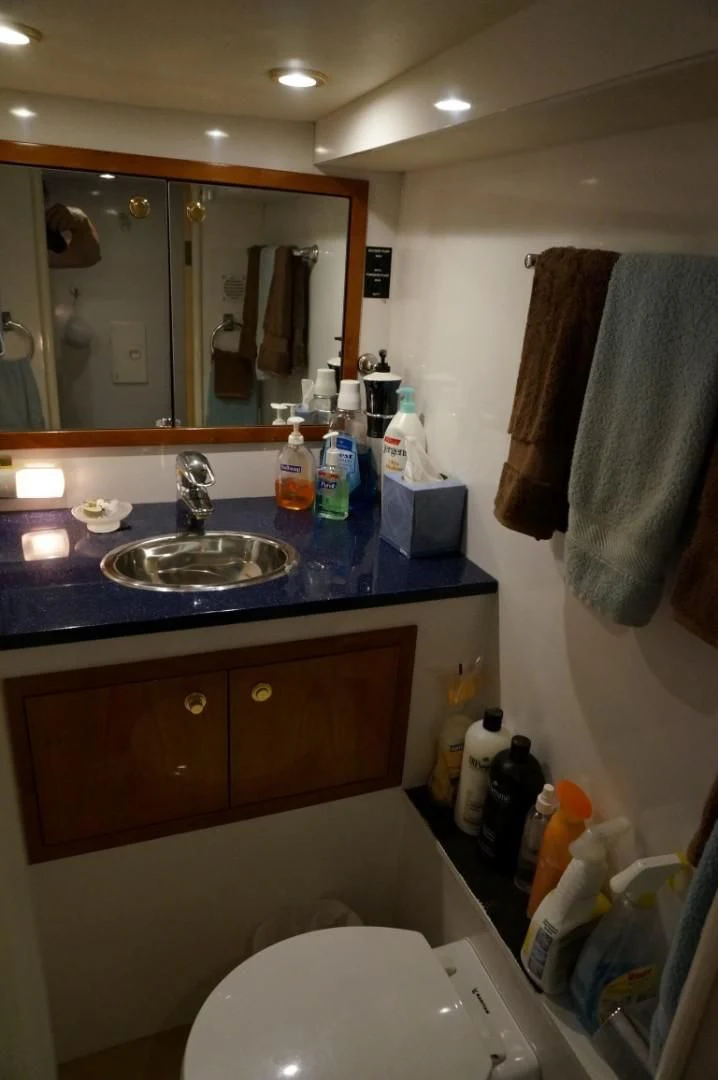 a bathroom with a sink and a mirror aboard SWEET LADY Yacht for Sale