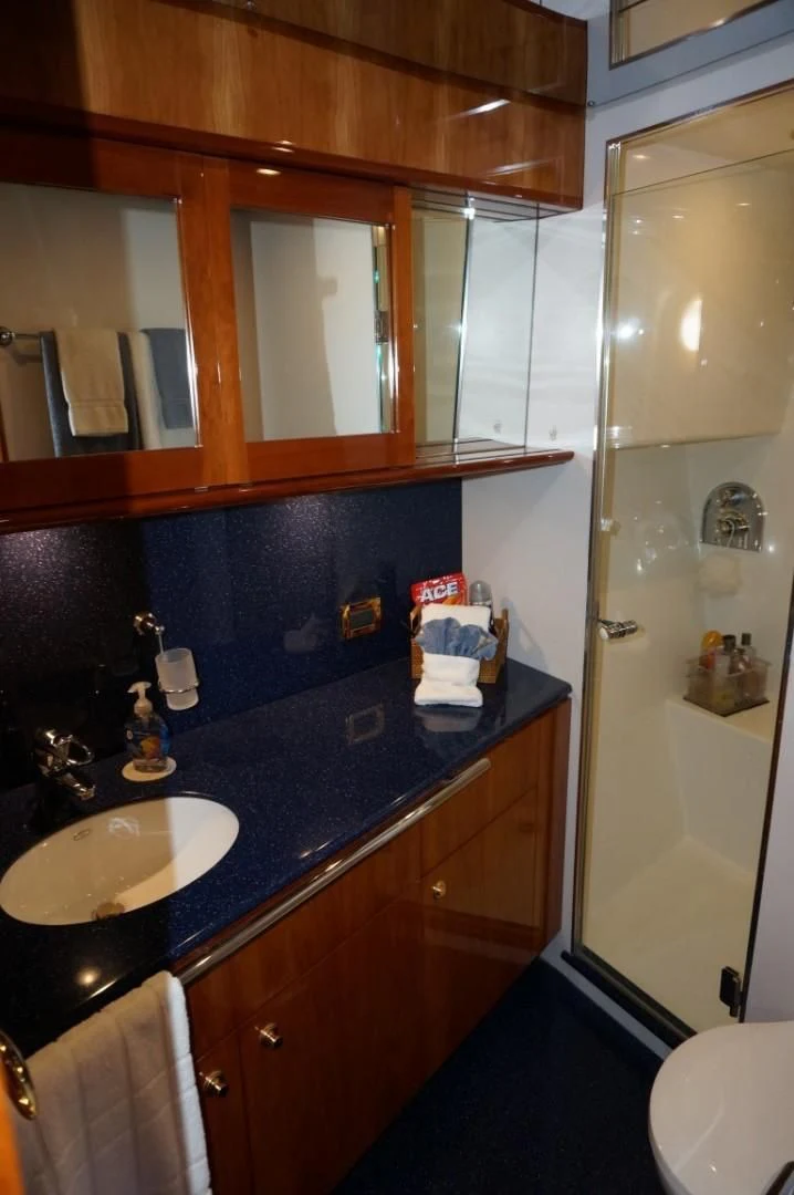 a bathroom with a sink and a mirror aboard SWEET LADY Yacht for Sale