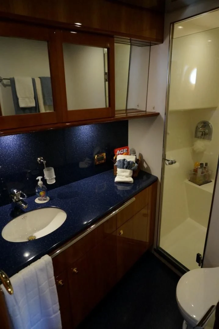 a bathroom with a sink and mirror aboard SWEET LADY Yacht for Sale