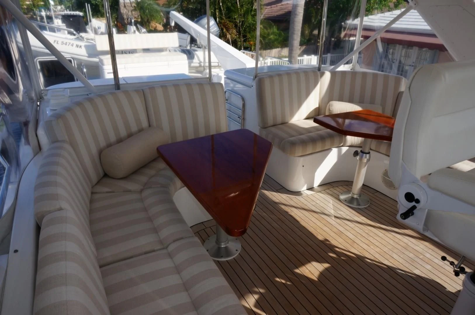 a glass of red wine on a table outside on a deck aboard SWEET LADY Yacht for Sale