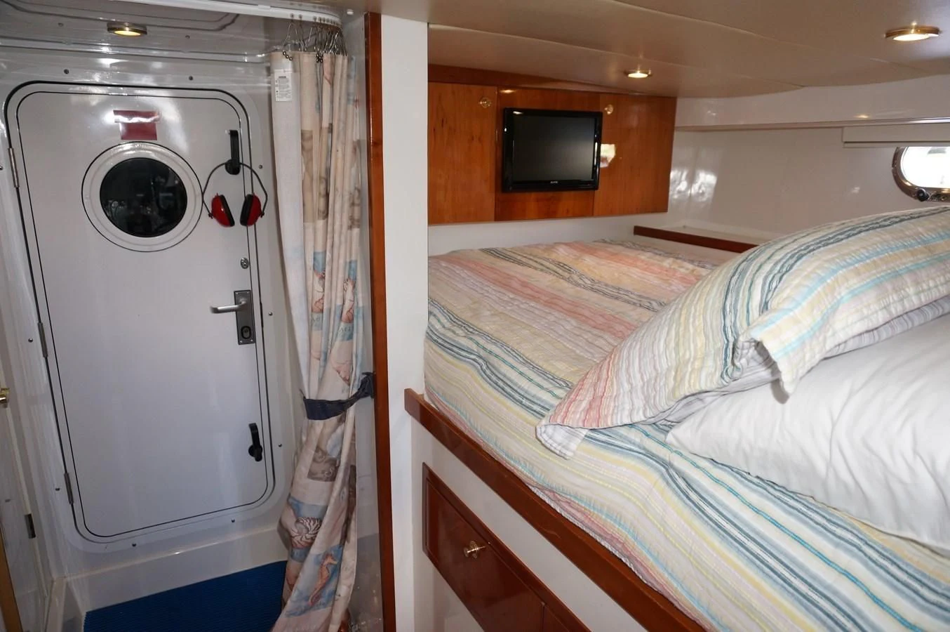 a room with a bed and a television aboard SWEET LADY Yacht for Sale