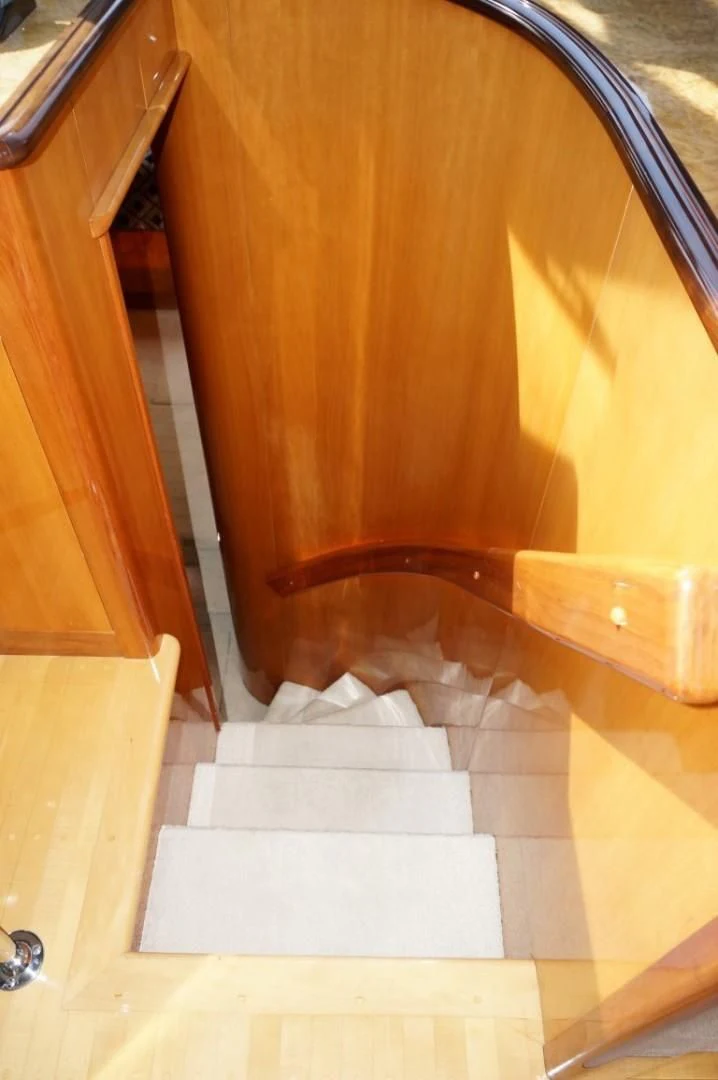 a wooden staircase with a wooden railing aboard SWEET LADY Yacht for Sale