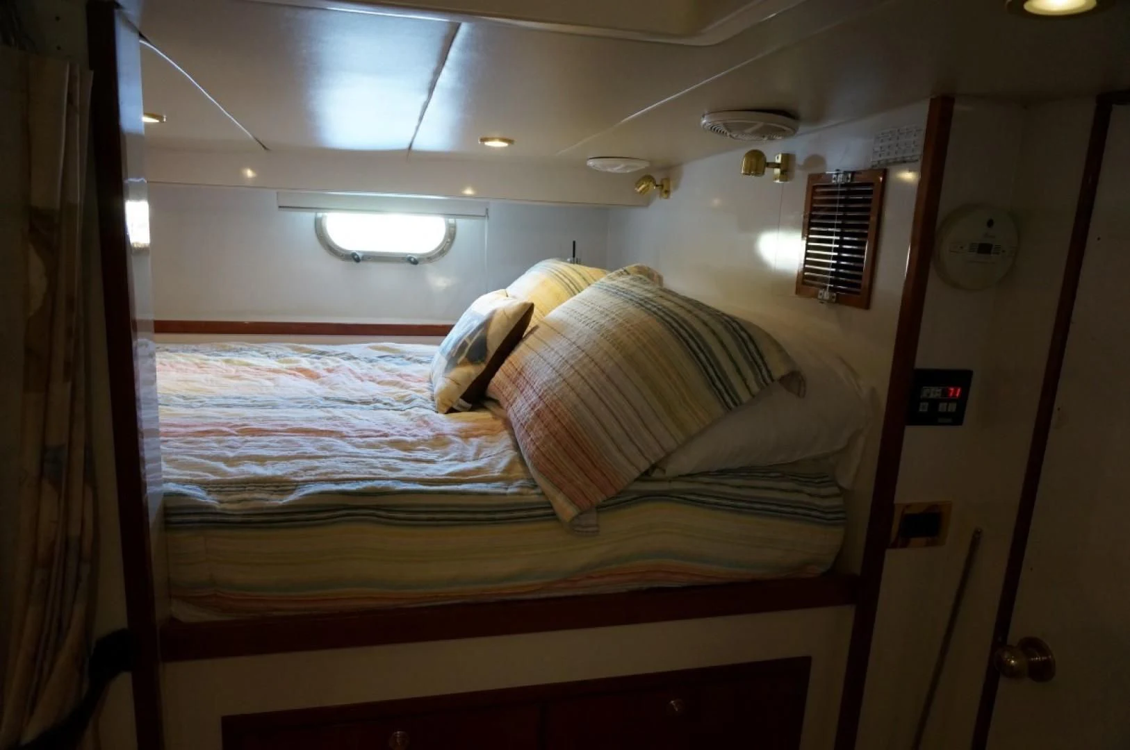 a bed with a window aboard SWEET LADY Yacht for Sale