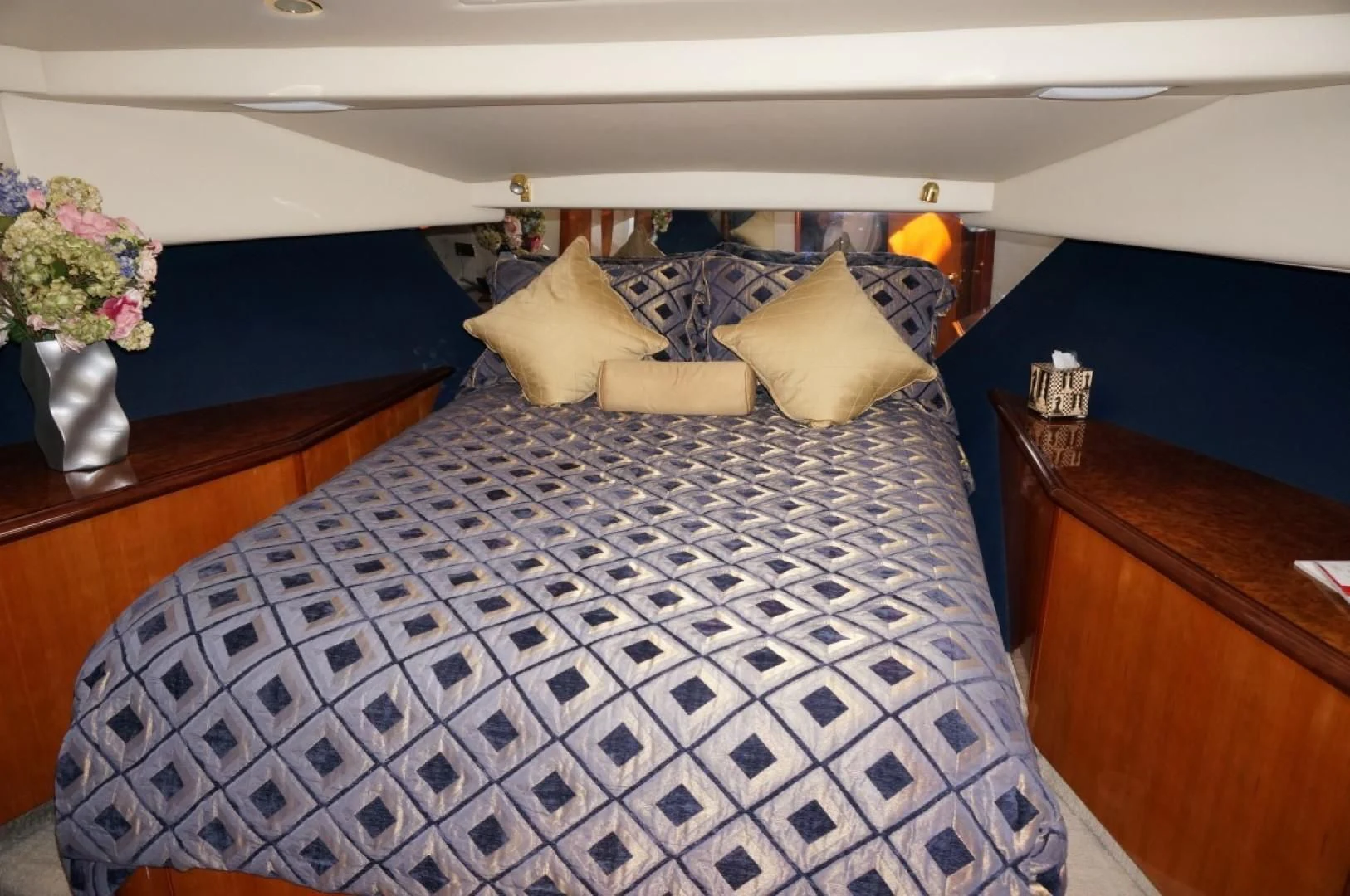 a bed with a blue and white checkered comforter aboard SWEET LADY Yacht for Sale