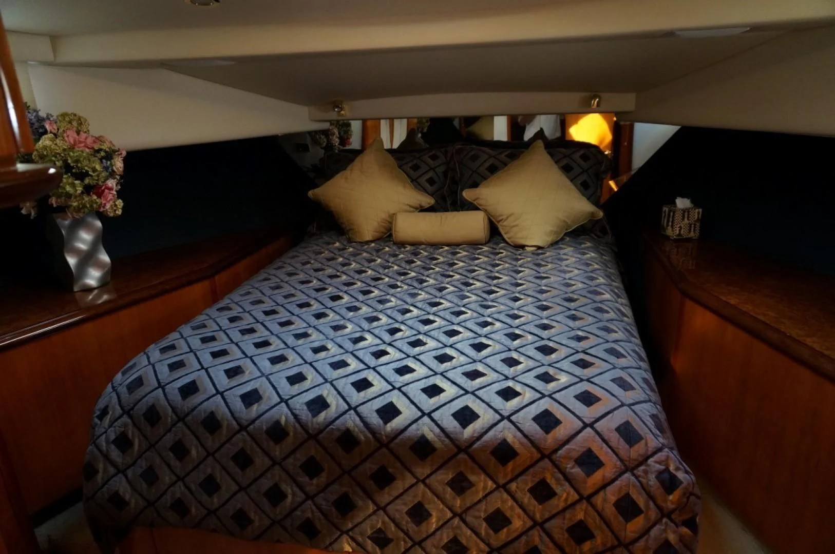 a bed with a blue and white checkered comforter aboard SWEET LADY Yacht for Sale