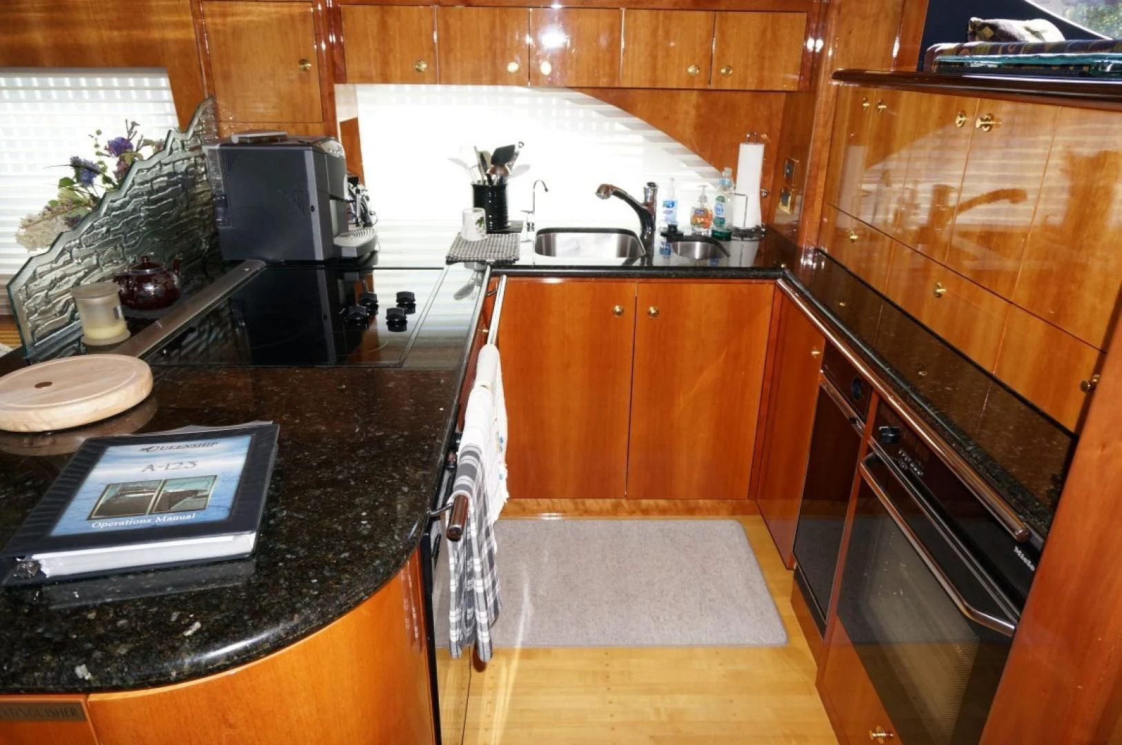 a kitchen with wooden cabinets aboard SWEET LADY Yacht for Sale