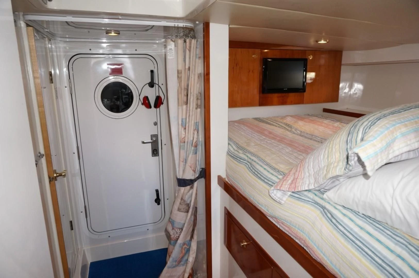 a bedroom with a bed and a television aboard SWEET LADY Yacht for Sale