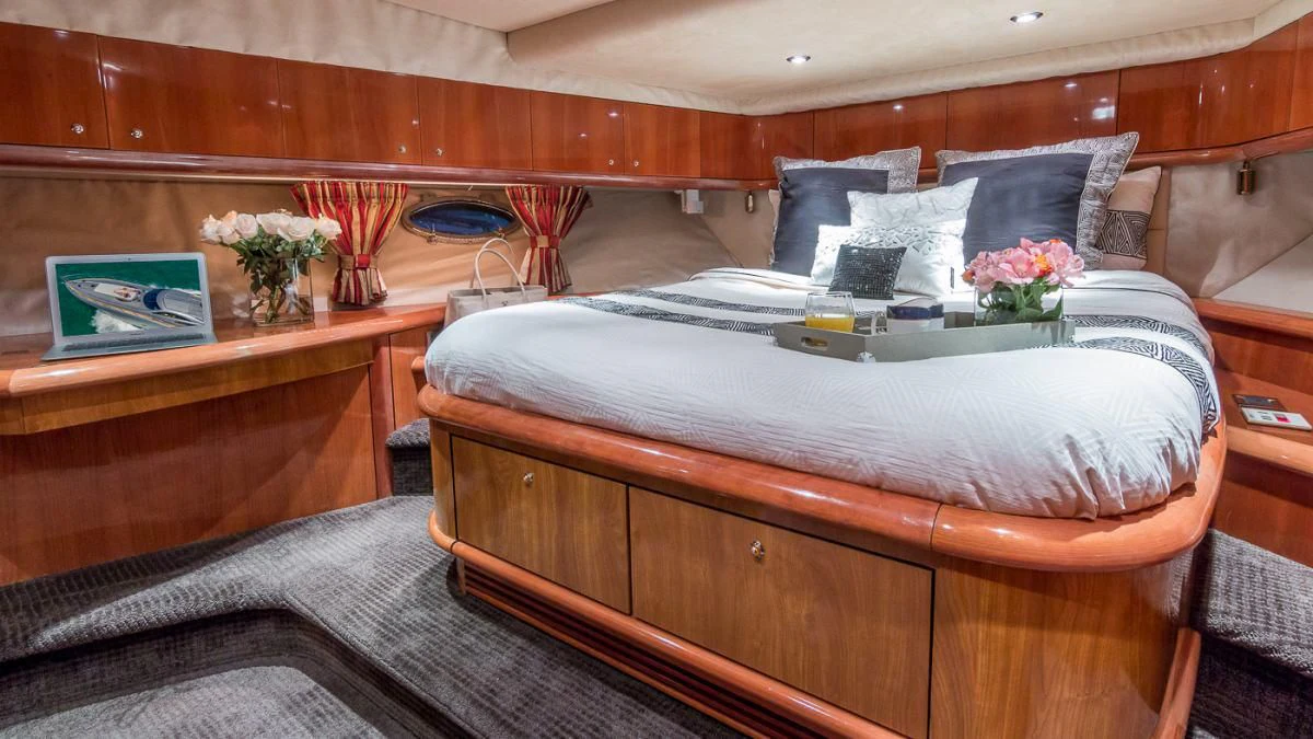 a bed with a wooden headboard aboard H2 Yacht for Sale
