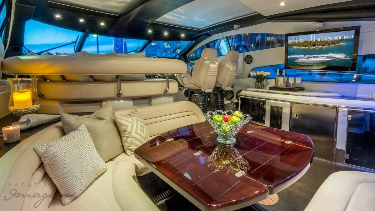 a room with a table and couches aboard H2 Yacht for Sale