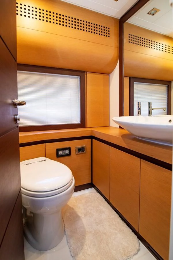 a bathroom with a toilet and sink aboard UPTOWN GIRL Yacht for Sale