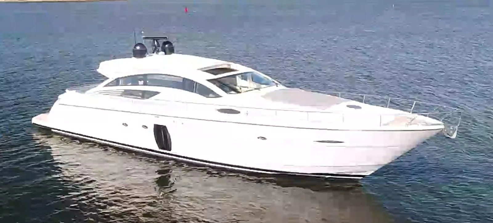 a white yacht on the water aboard UPTOWN GIRL Yacht for Sale