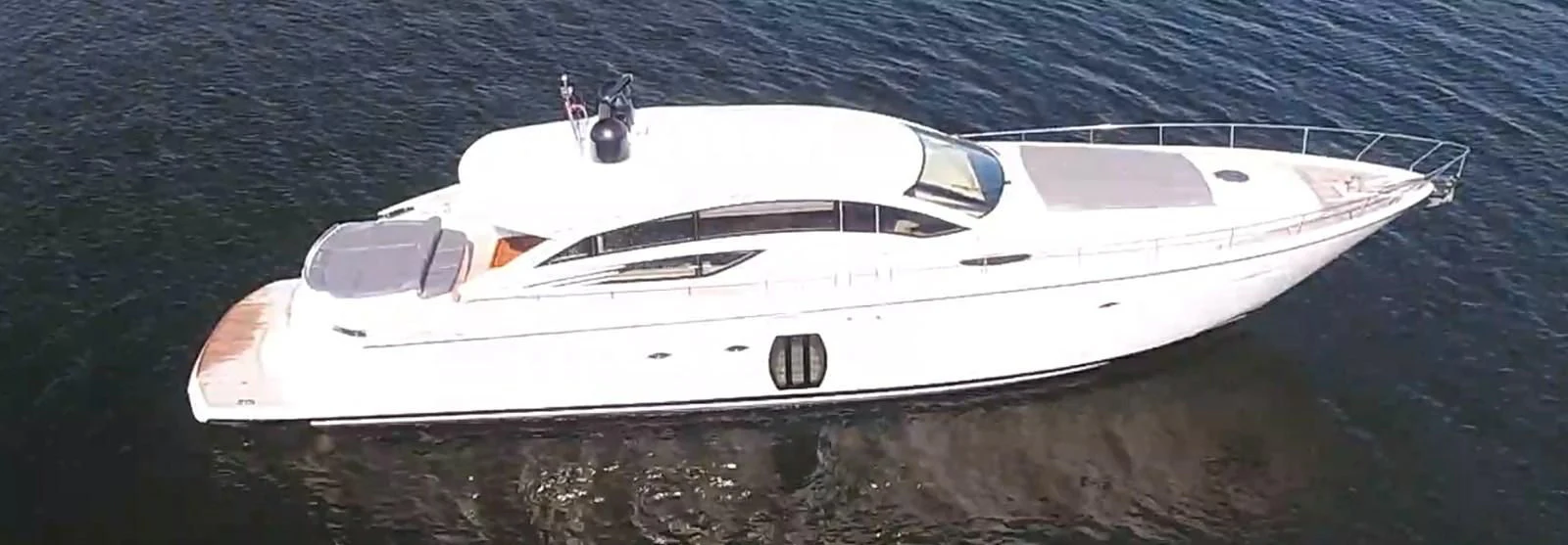 a white yacht on the water aboard UPTOWN GIRL Yacht for Sale