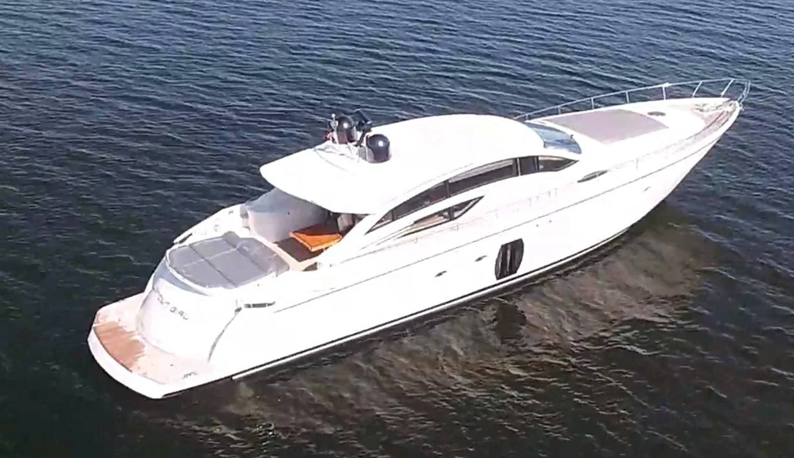 a white boat on the water aboard UPTOWN GIRL Yacht for Sale