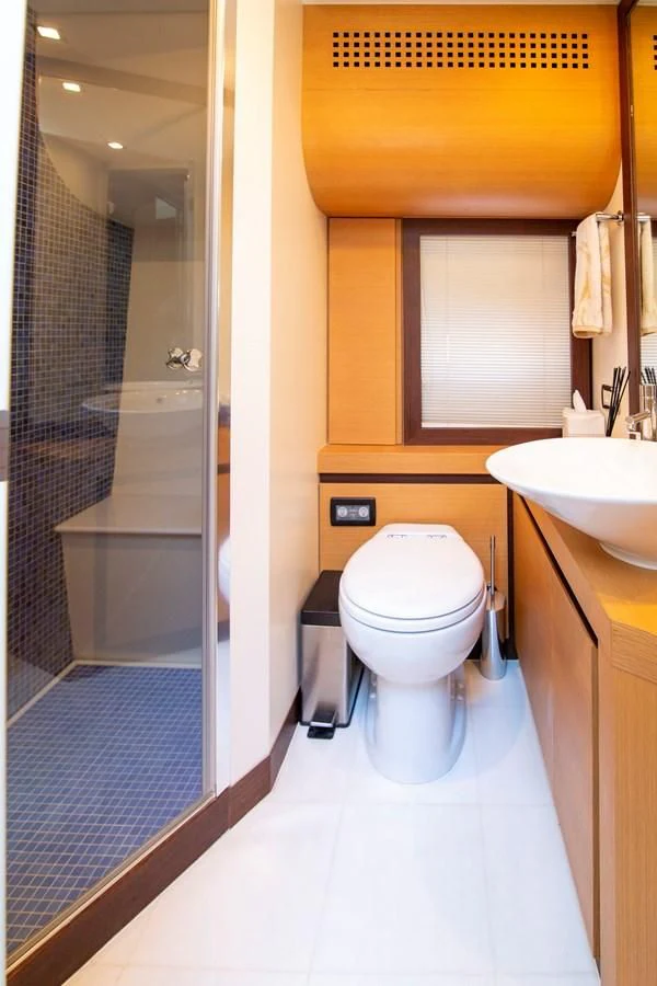 a bathroom with a glass shower door aboard UPTOWN GIRL Yacht for Sale
