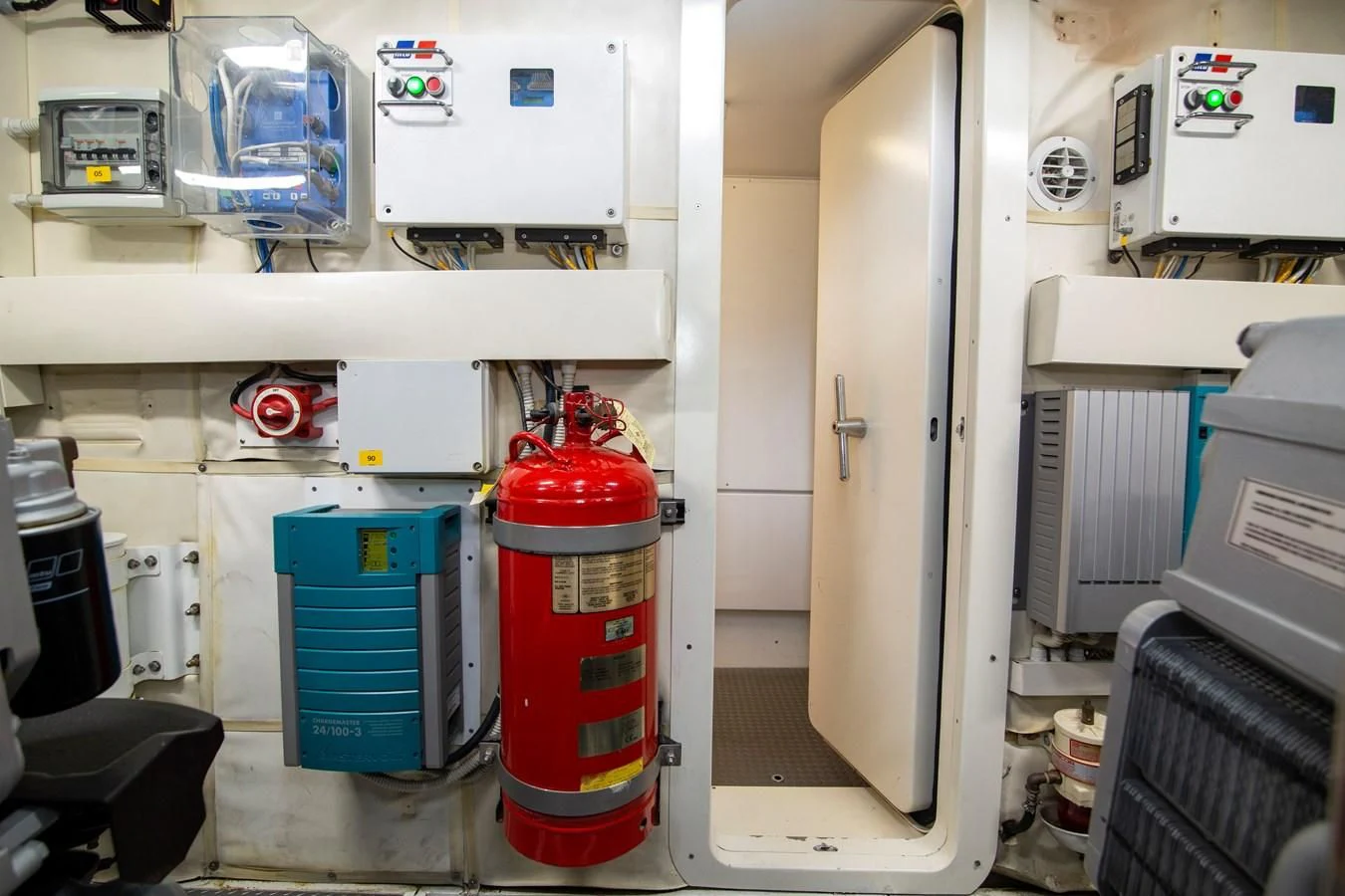 a red and white fire extinguisher in a room aboard UPTOWN GIRL Yacht for Sale