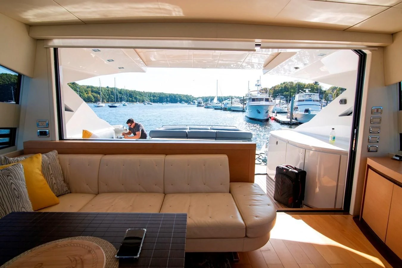 a person sitting on a couch in a living room aboard UPTOWN GIRL Yacht for Sale