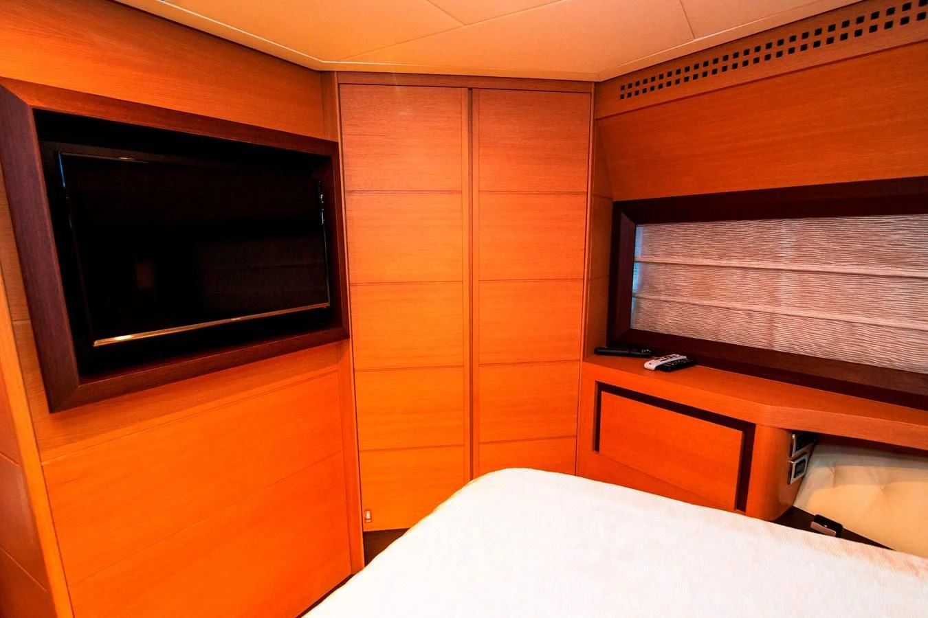 a room with a bed and a television aboard UPTOWN GIRL Yacht for Sale