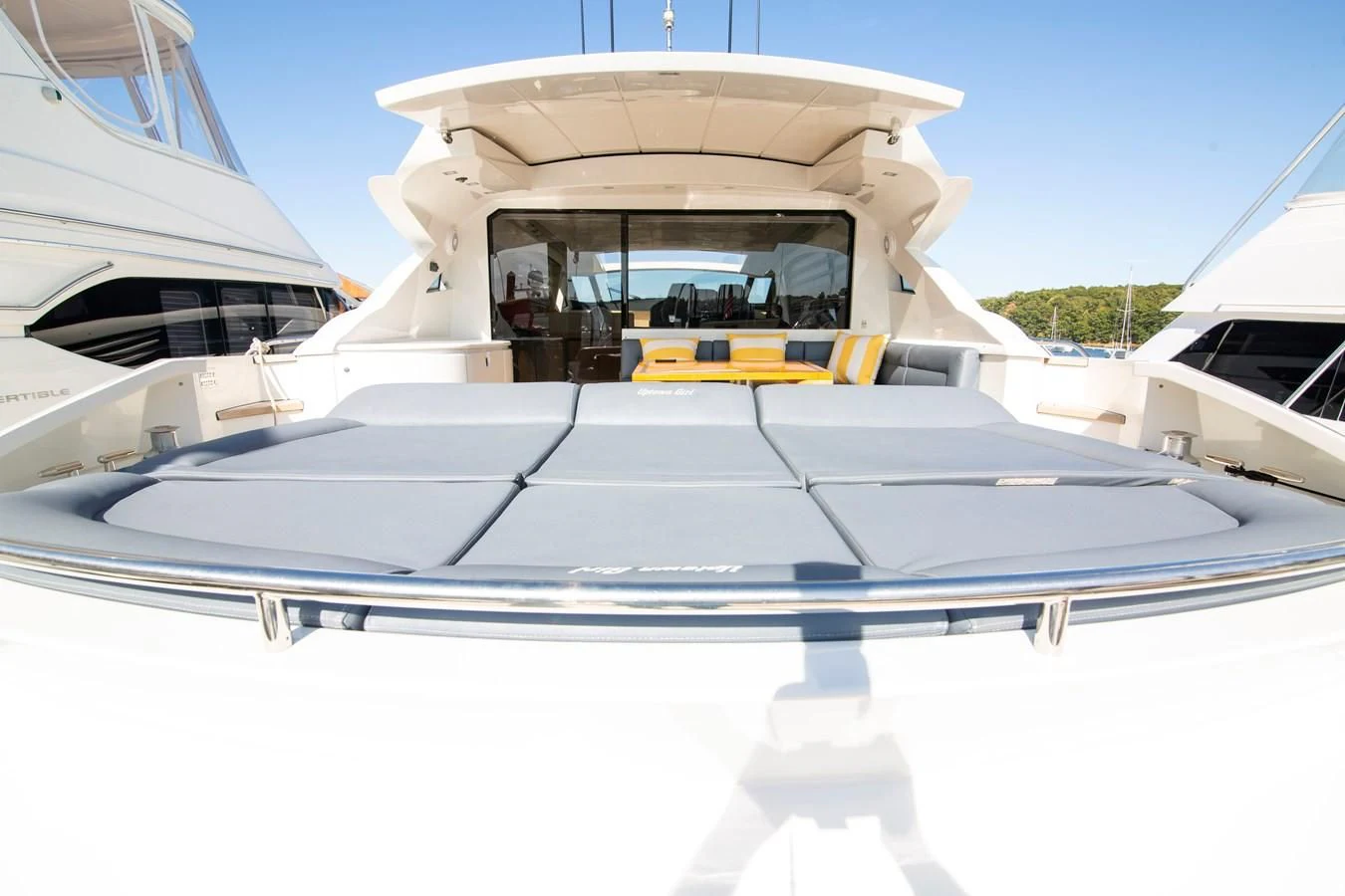 a white boat with a yellow stripe aboard UPTOWN GIRL Yacht for Sale