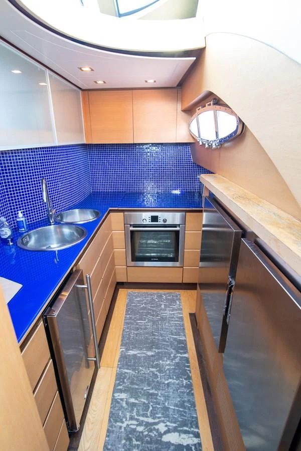 a kitchen with a stainless steel stove aboard UPTOWN GIRL Yacht for Sale
