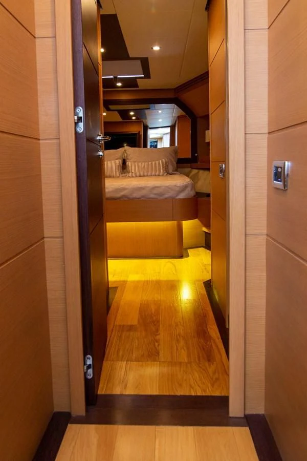 a hallway with a bed and a door aboard UPTOWN GIRL Yacht for Sale