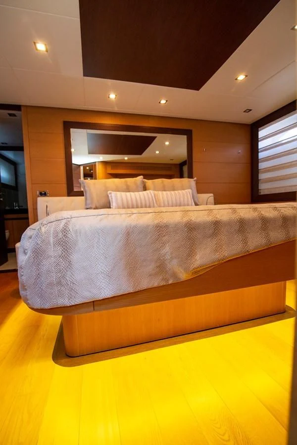 a bed with a tv on the wall aboard UPTOWN GIRL Yacht for Sale