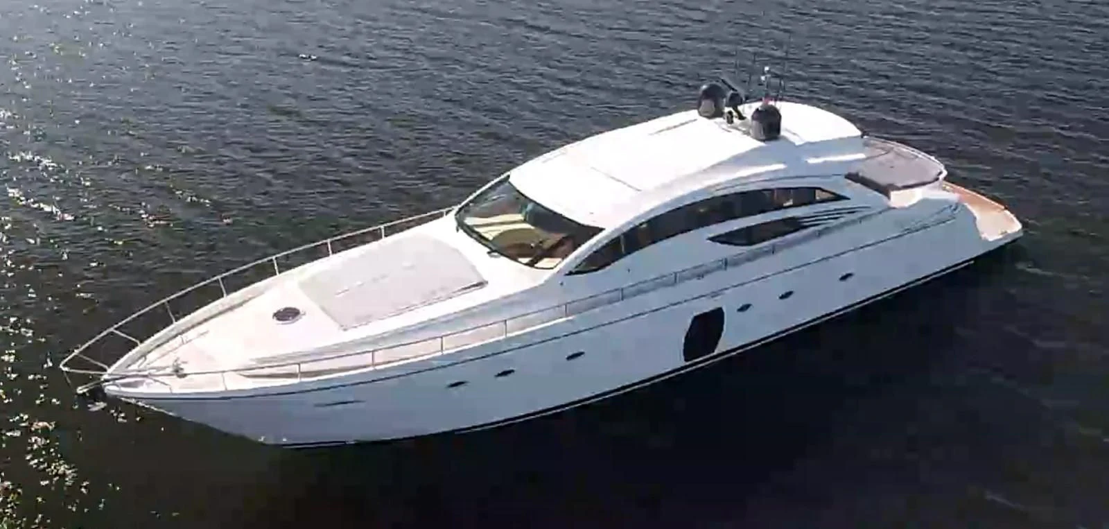 a white boat on the water aboard UPTOWN GIRL Yacht for Sale