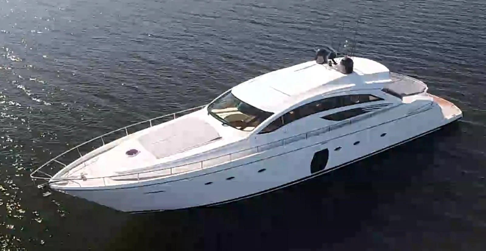 a white boat on the water aboard UPTOWN GIRL Yacht for Sale