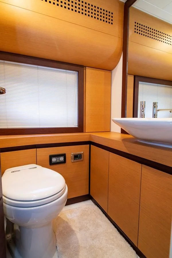 a bathroom with a toilet and a sink aboard UPTOWN GIRL Yacht for Sale
