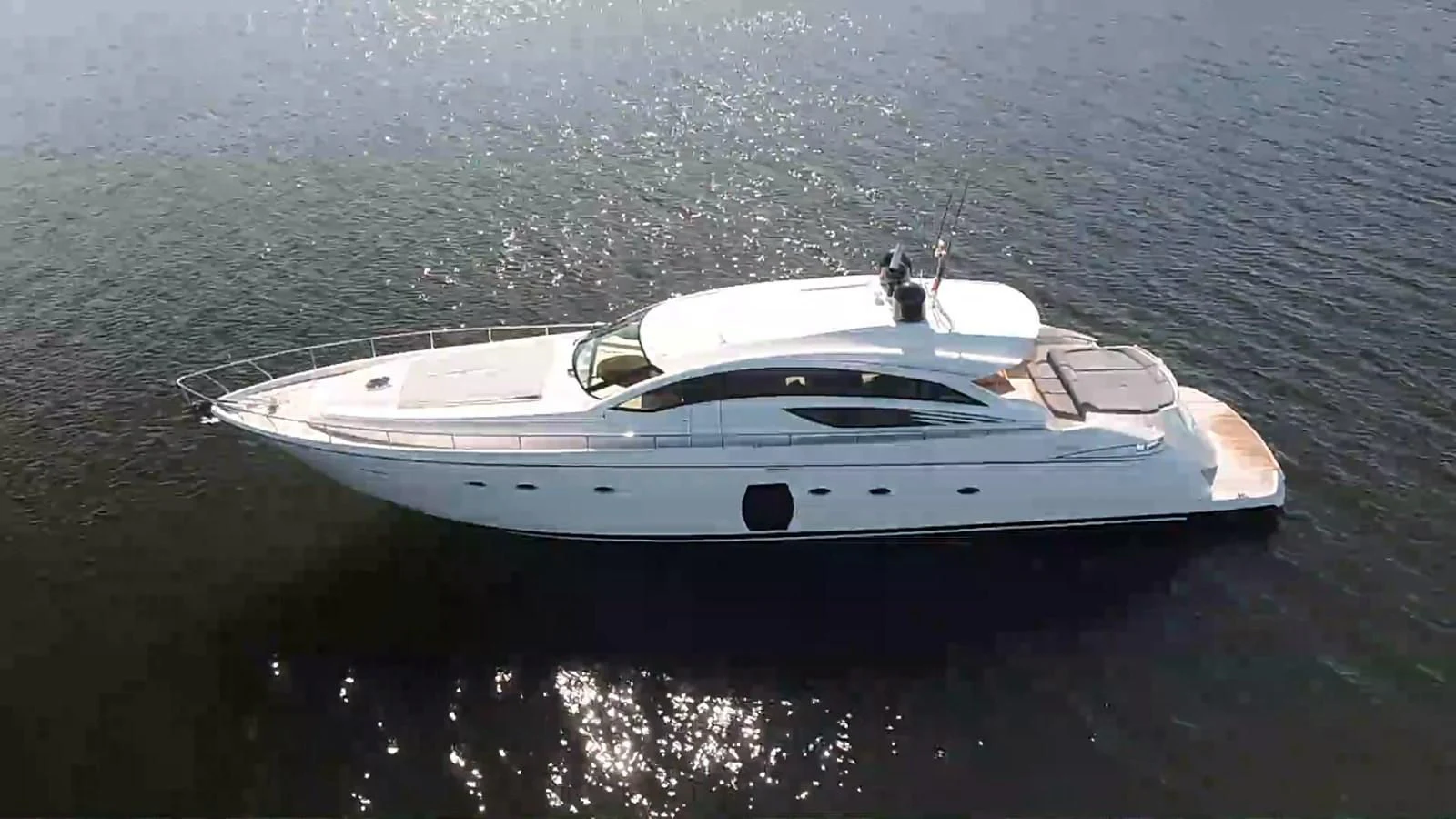 a white yacht in the water aboard UPTOWN GIRL Yacht for Sale