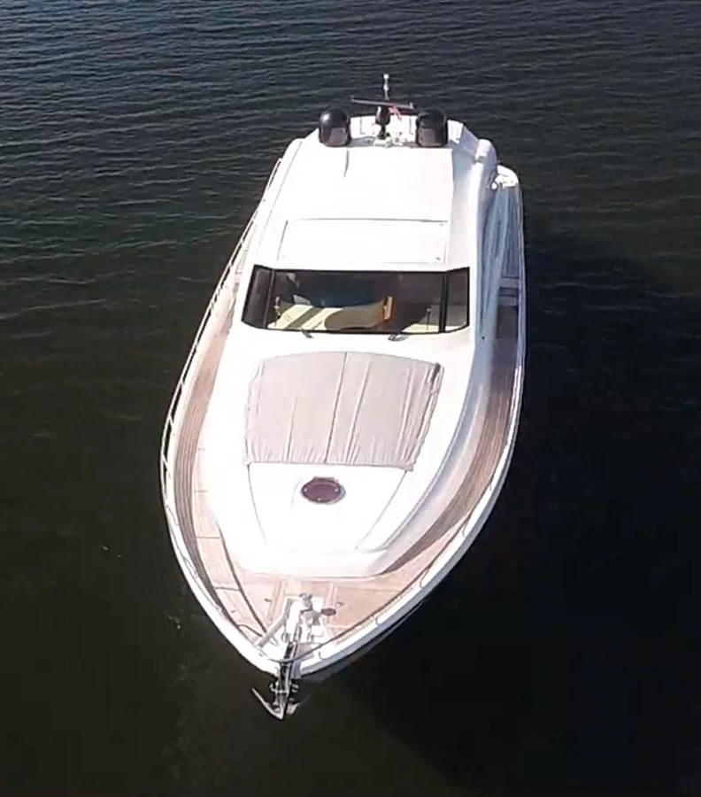 a white boat on water aboard UPTOWN GIRL Yacht for Sale
