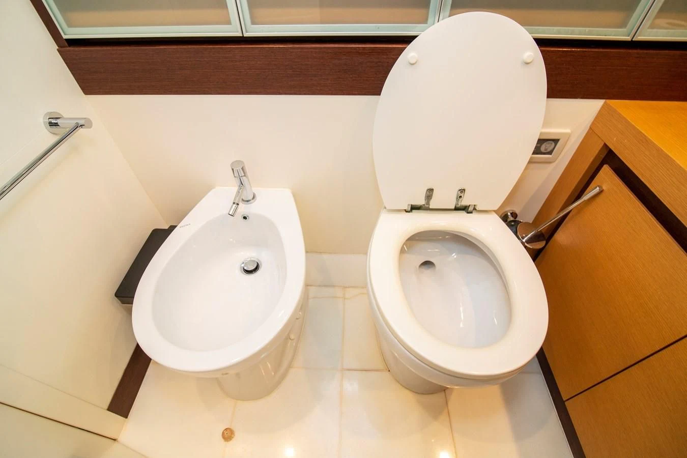 a toilet and a bidet in a bathroom aboard UPTOWN GIRL Yacht for Sale