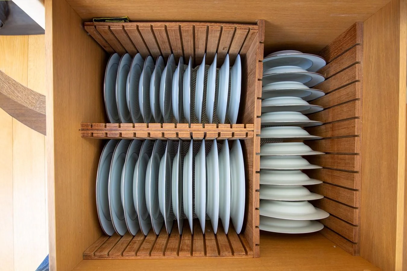 a wooden cabinet with a stack of books on it aboard UPTOWN GIRL Yacht for Sale