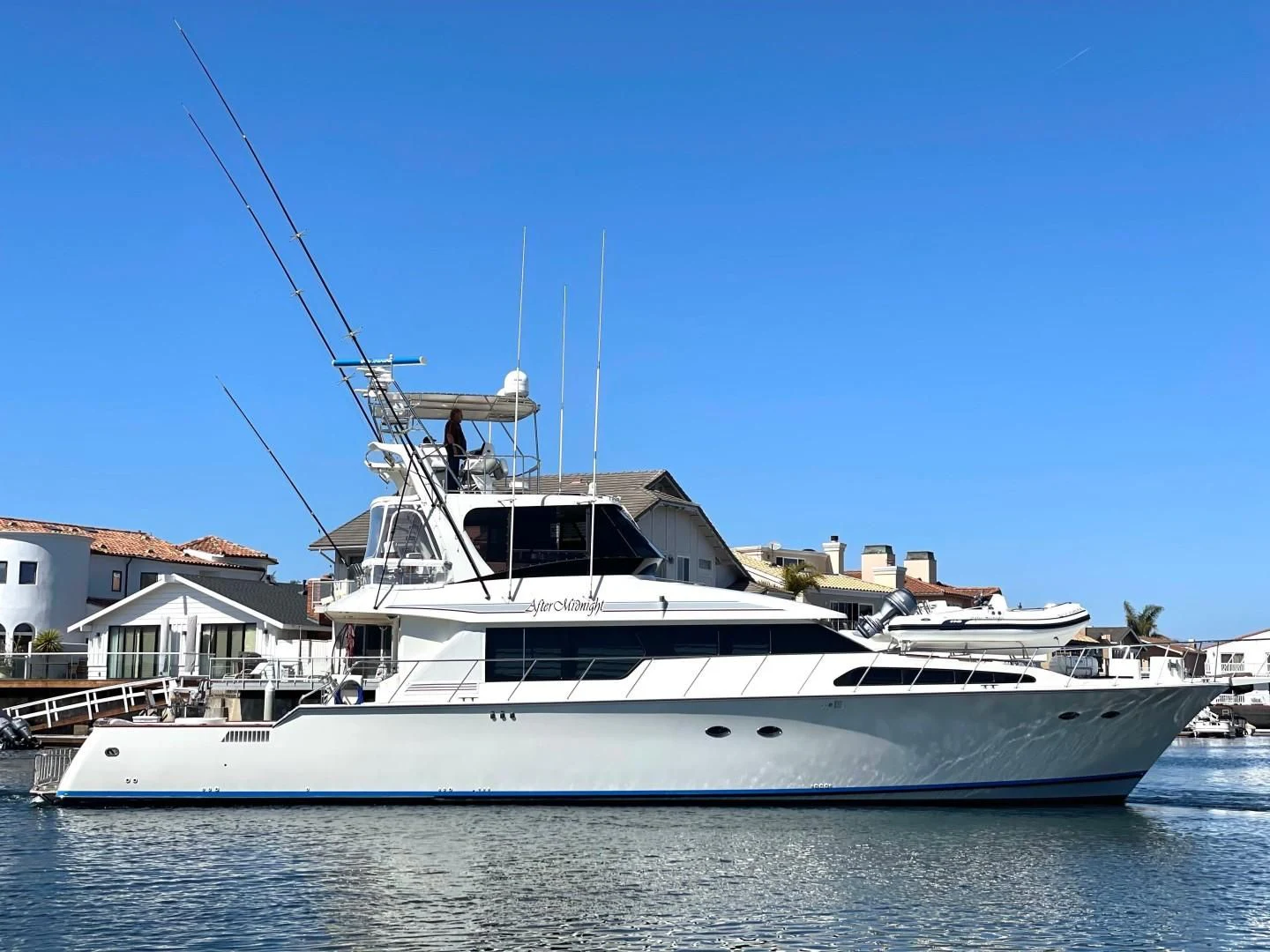 a white yacht in the water aboard AFTER MIDNIGHT Yacht for Sale