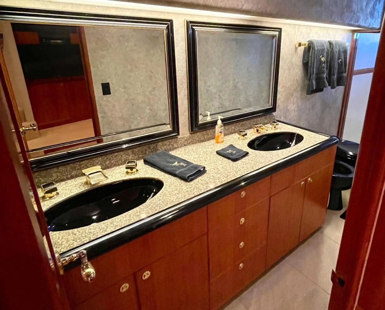 a bathroom with a countertop sink and a mirror aboard AFTER MIDNIGHT Yacht for Sale