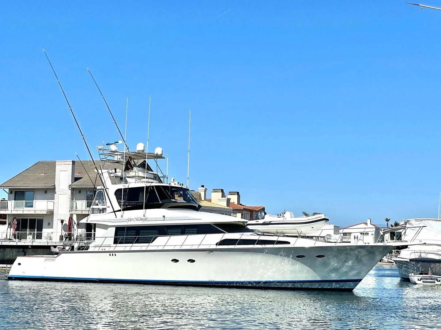 a large white yacht in the water aboard AFTER MIDNIGHT Yacht for Sale