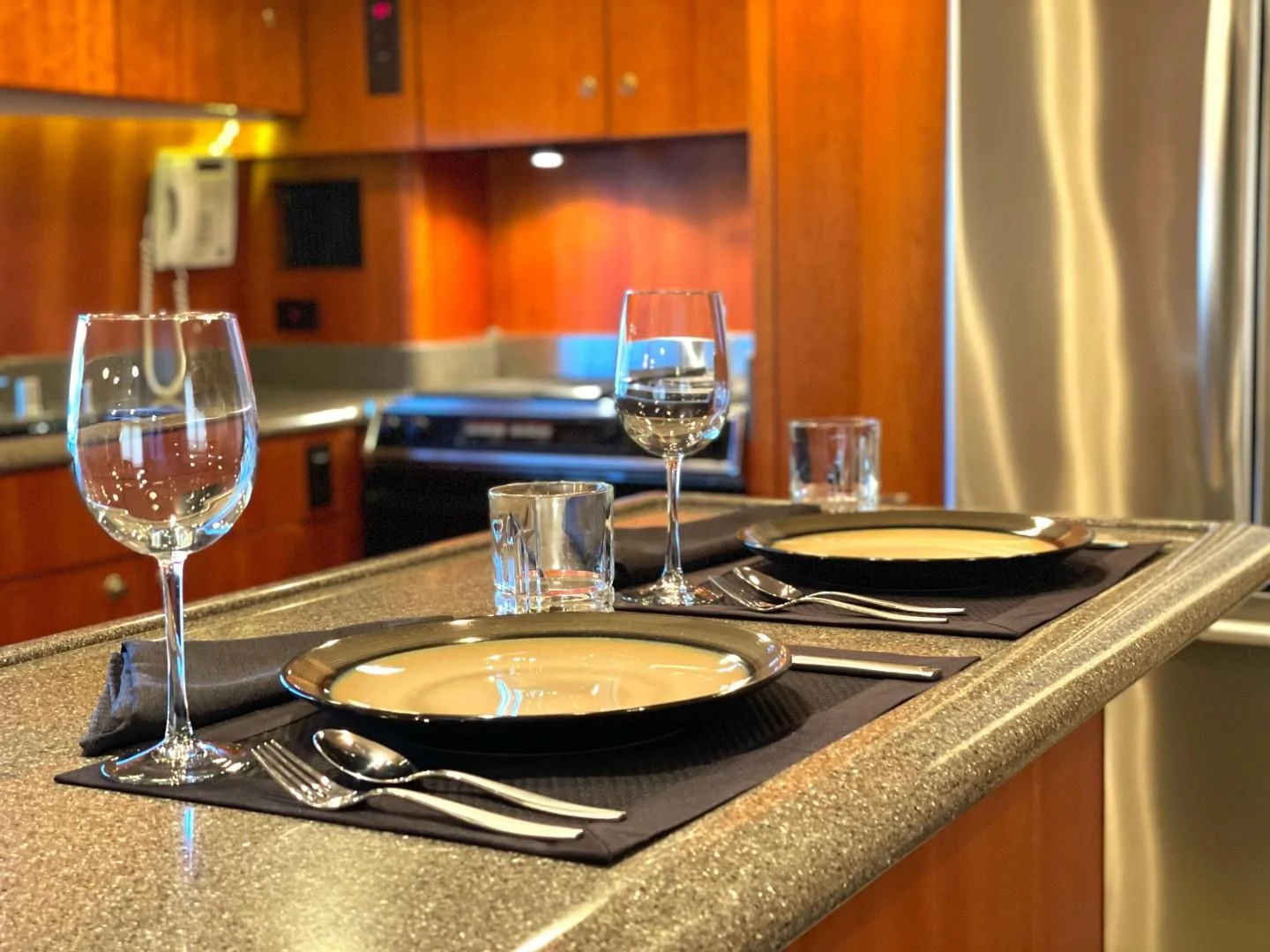 a table with plates and glasses on it aboard AFTER MIDNIGHT Yacht for Sale