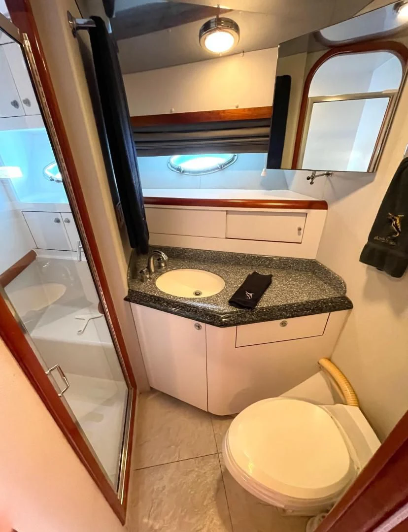 a bathroom with a sink and a toilet aboard AFTER MIDNIGHT Yacht for Sale