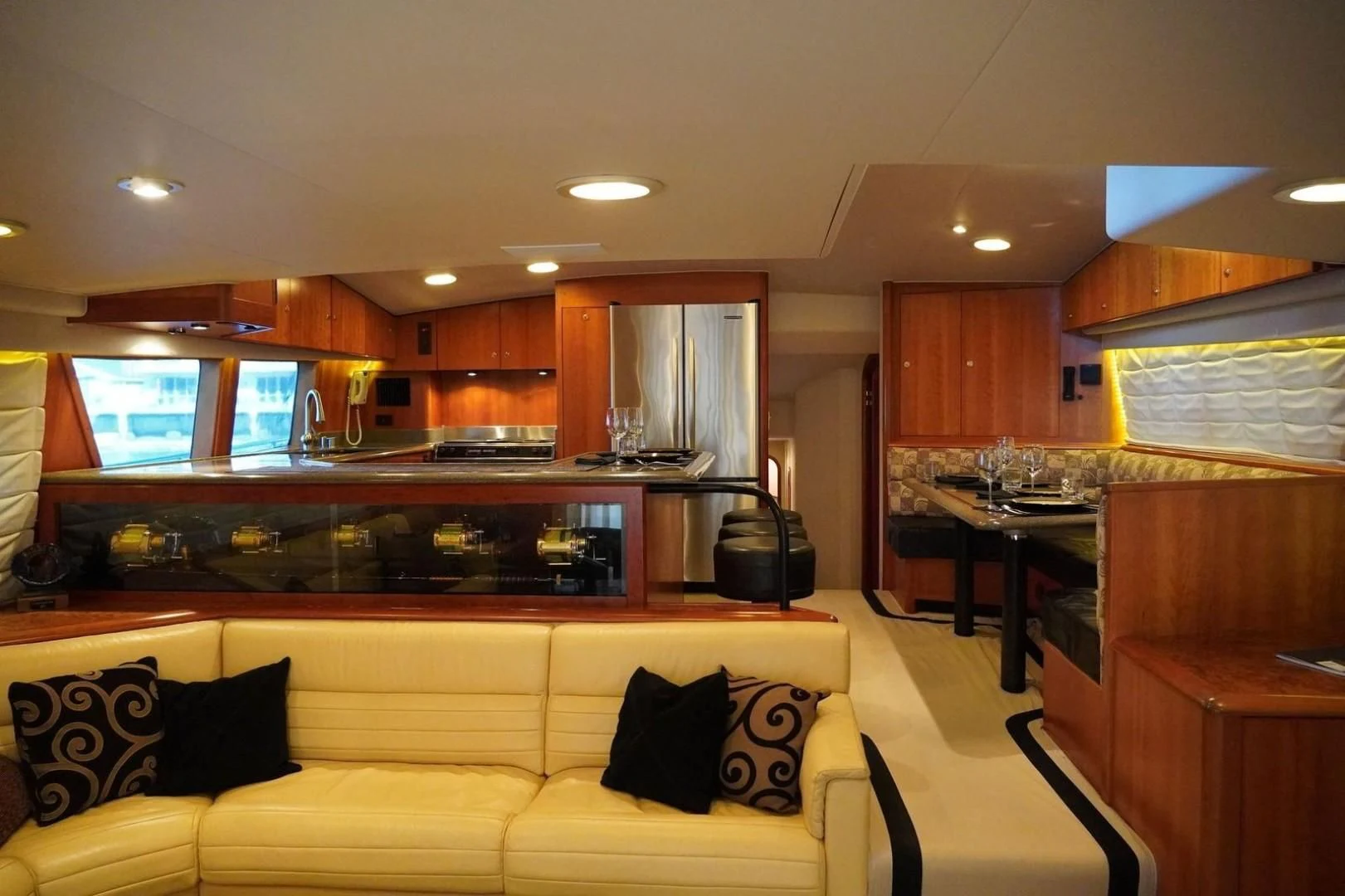 a living room with a yellow couch aboard AFTER MIDNIGHT Yacht for Sale